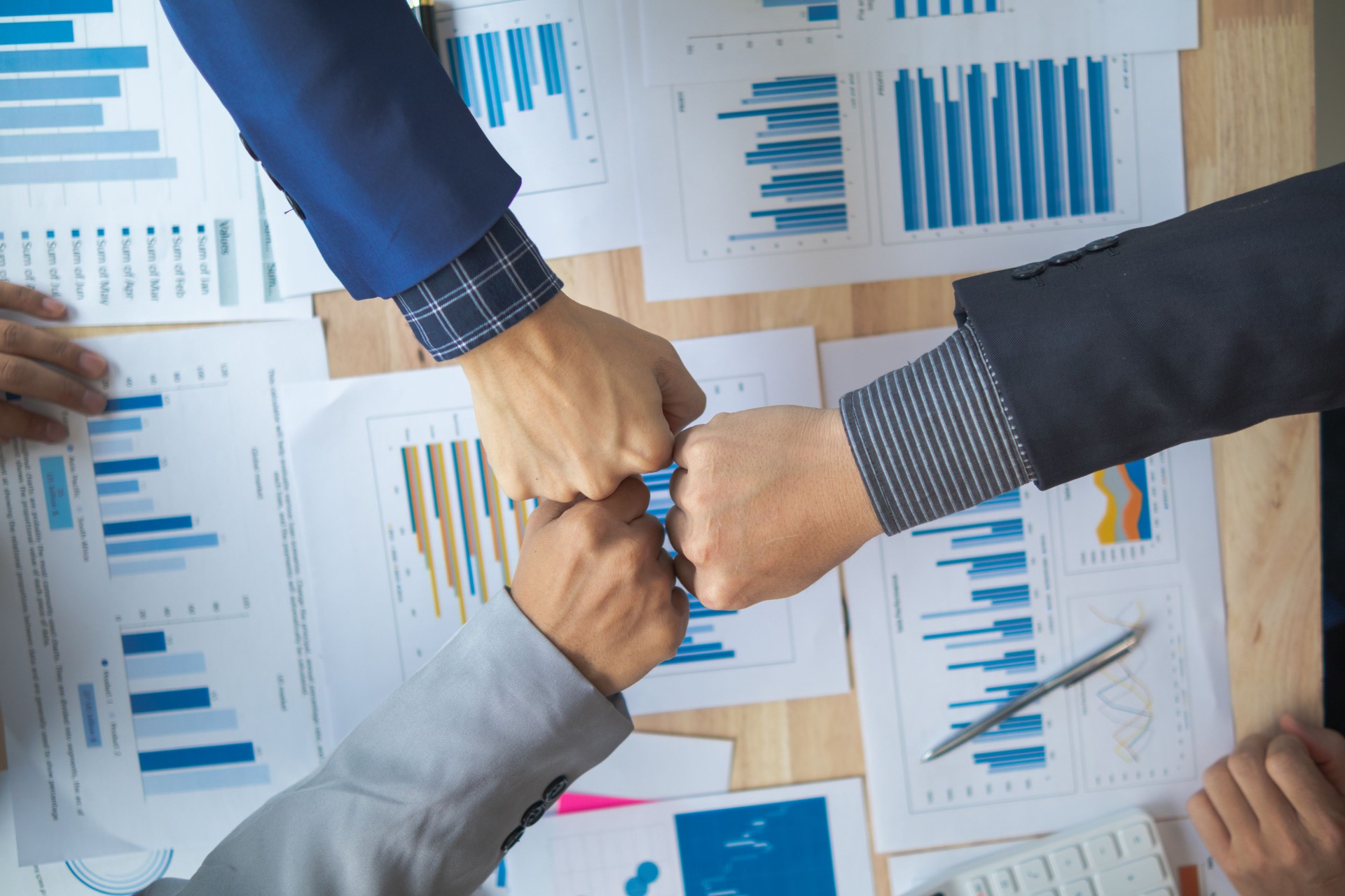 A group of businesspeople and investors meet to discuss market's success in past quarter. idea of setting up a marketing consulting team and working together as a team made it a success.